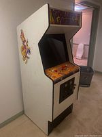 Front and side view of the vintage Rolling Thunder arcade cabinet showing controls, screen, and side artwork.