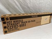 Photo showing front side of rectangular cardboard box with printed Mattel Hot Wheels Straight Track 50-Pack text and product code CCF02-9993.