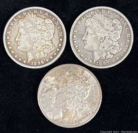 Three Morgan dollars obverse view showing dates 1896, 1897 and wear