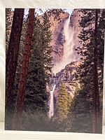 Full view of the metal photo print showing Yosemite Falls framed by pine trees and rocky terrain.