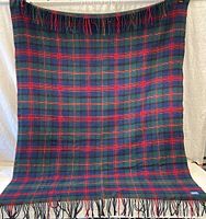 Full view of the plaid Pendleton wool throw blanket hung vertically to show full size and design.