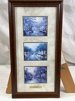 Photo of the framed trio of Thomas Kinkade prints arranged vertically with title plate.