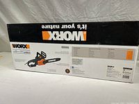 Side view of the factory sealed box with detailed product information and images of the chain saw.