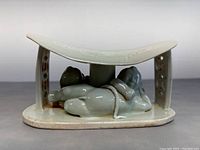 Front view showing entire pillow and reclining figure beneath curve