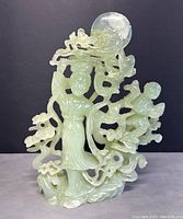 Front view of the jadeite carving against black background
