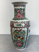 Front and side view of the tall porcelain vase showing detailed floral and butterfly hand-painted decoration in pink, green, red, and yellow.