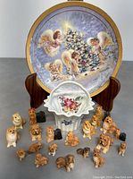 Photo showing all items including the 20 miniature dog figurines arranged in front of the collector's plate and the porcelain basket.