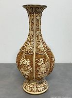 Full front view of large white cinnabar style vase showing overall shape and relief decoration.