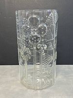 Front view of clear glass vase showing embossed abstract floral and bubble patterns.