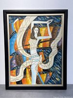 Full view of the framed modern abstract oil painting showing the female figure composed with geometric shapes and colorful background.