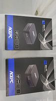 Two sealed ACEPC AK1 mini PC retail boxes side by side.