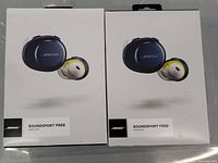 Two unopened original retail boxes of BOSE SoundSport Free Wireless Earbuds showing product image and branding on front of boxes.
