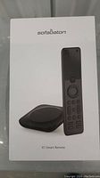 Front box image showing Sofabaton X1 Smart Remote with accompanying hub device in black.