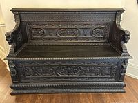 Front view of bench showing overall structure and carvings