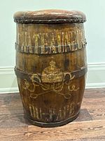 Front view of oak barrel stool showing painted 'Chateuneuf Du-Pape' text and overall shape