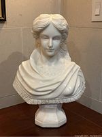 Front view of entire marble bust on pedestal base.