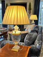 Pair of lamps lit on side table in living room setting
