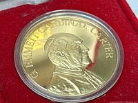 Obverse side of the gold-tone medal showing detailed profile portrait and inscription.