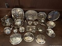 Overview of entire silver plated serving lot on floor