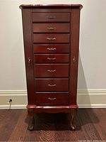 Front view of closed cabinet showing drawers, legs and overall finish