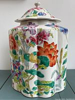 Front view of the ginger jar showing scalloped cylindrical body and floral pattern