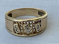 Front view showing three rectangular diamond clusters set on a lattice background.