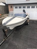 Front three-quarter view of fiberglass hull on trailer