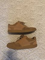 Side view of both light brown nubuck suede Nike shoes, showing overall shape and condition, size 12 men's.