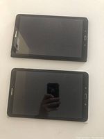 Two Samsung tablets from the front showing intact screens and buttons.