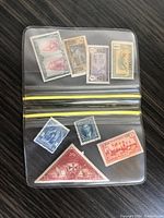 Front side of world stamps displayed inside a clear plastic sleeve showing various countries and designs.