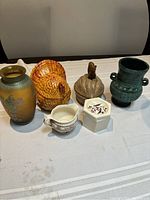 Front view showing all six items arranged on a table with a white cloth.