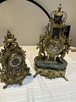 Front view showing both clocks side by side on white surface
