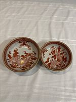 Two vintage Kutaniyaki porcelain bowls placed side by side showing overall size difference and design similarity.