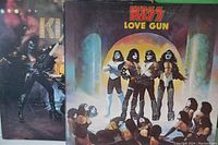 Close up of KISS Love Gun vinyl album cover showing full artwork and band members in costume.