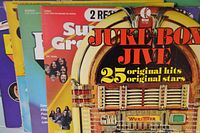 Photo showing front covers of five vinyl albums in used condition, colorful covers with titles Juke Box Jive, Superstars Greatest Hits, Fantastic, Sound Explosion, Todays Super Greats.
