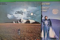Album covers showing Ringo Starr's Goodnight Vienna and John Lennon's Mind Games albums, both with surreal and moonlit artwork.