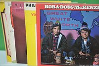 Photo showing the front covers of five comedy vinyl albums, including Bob & Doug McKenzie Great White North and others partially visible behind it