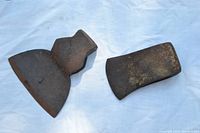 Photo showing both axe heads scaled on a white background with visible rust and wear.