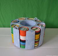 Front view of the plastic display case filled with multiple stacks of colorful Jello plastic coins.