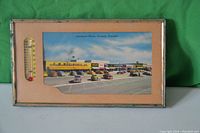 Framed 1955 Lawrence Plaza photo in Toronto with thermometer on left and vintage cars in parking lot.