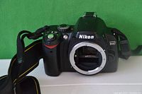 Front view of Nikon D40 camera body showing lens mount and neck strap attached.