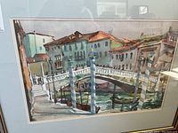 Overall view of the framed watercolor artwork depicting a bridge over water with buildings in the background