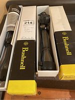 Two Bushnell rifle scopes displayed in their original boxes with product literature visible.