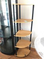 Full view of the five shelf corner bookcase showing all shelves and black metal supports.