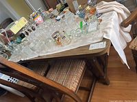 Top view showing dining table surface cluttered with glassware and other items which are not included.