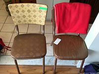 Top view of both vintage chairs side by side with red fleece throw on one.