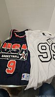 Photo showing both jerseys side by side, USA Basketball navy blue and white jersey with number 98