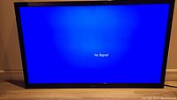 Front view of 42-inch Insignia TV screen displaying 'No Signal!' message.