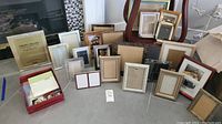 Wide shot of all photo frames included in the lot, showing variety in size, material, and color.