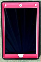 Front view of the Apple iPad with the screen off, showing the home button and rugged pink and black case edges.